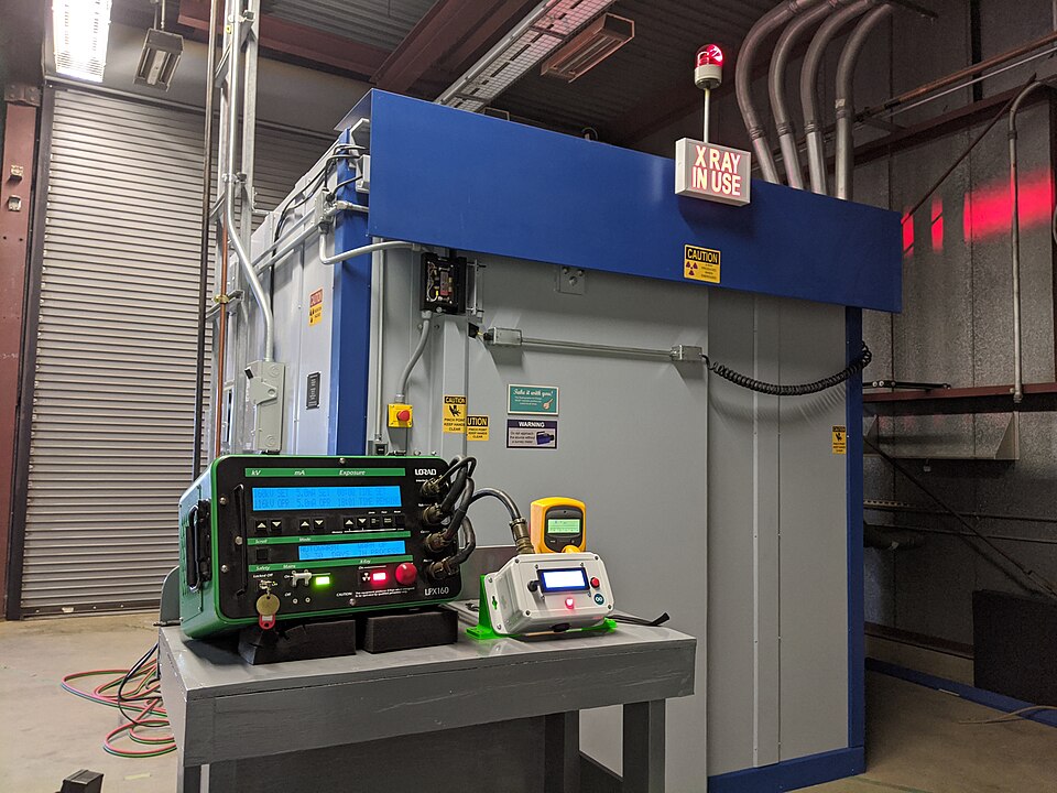 Radiographic testing of welds in a shielded X-ray enclosure